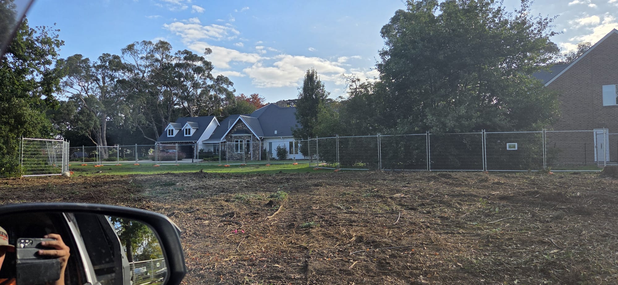 Fenced residential development site after vegetation clearing