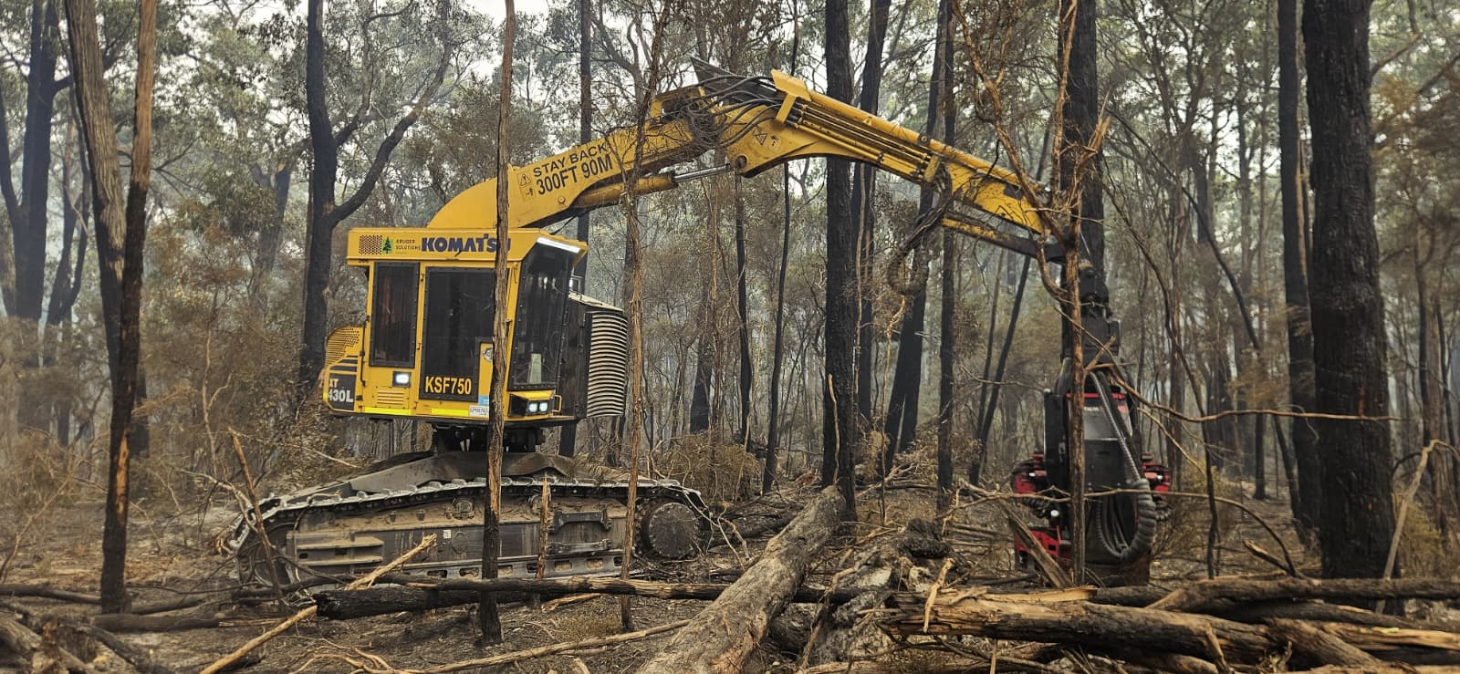 Harvester felling burnt timber during the fire response