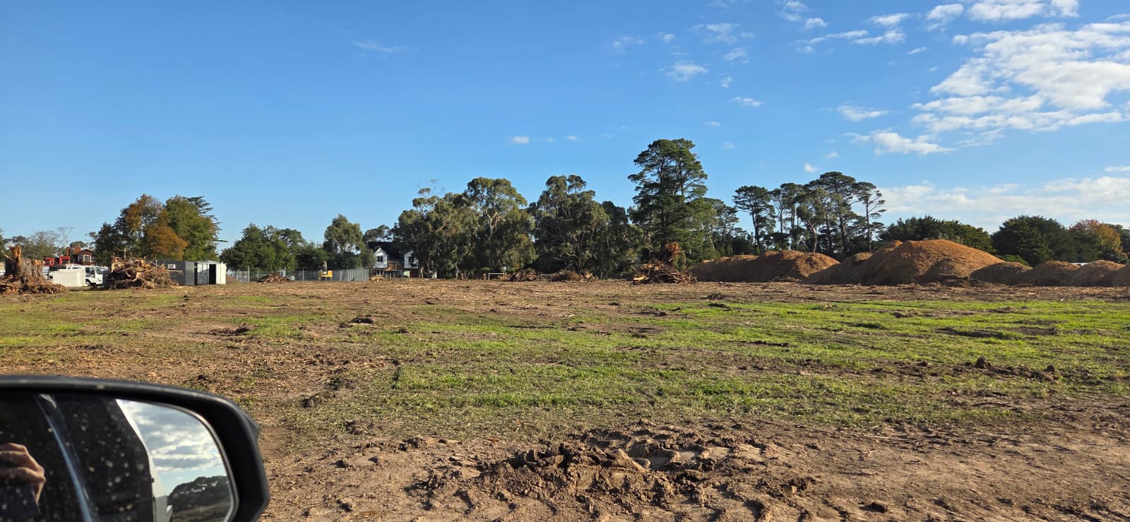 Recovered vegetation processed into landscaping mulch stockpiles